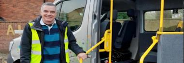 Councillor standing in front of the shopper bus