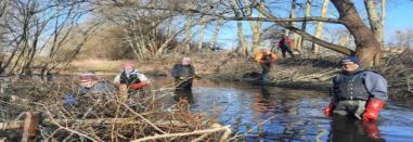 Volunteers creating berms in the river