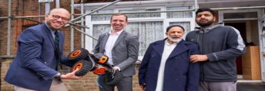 Elected Mayor Peter Taylor standing in front of a newly insulated home