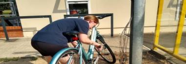 Cyclist locking bike to bike infrastructure.